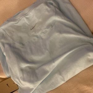 Light blue Nike fit top.